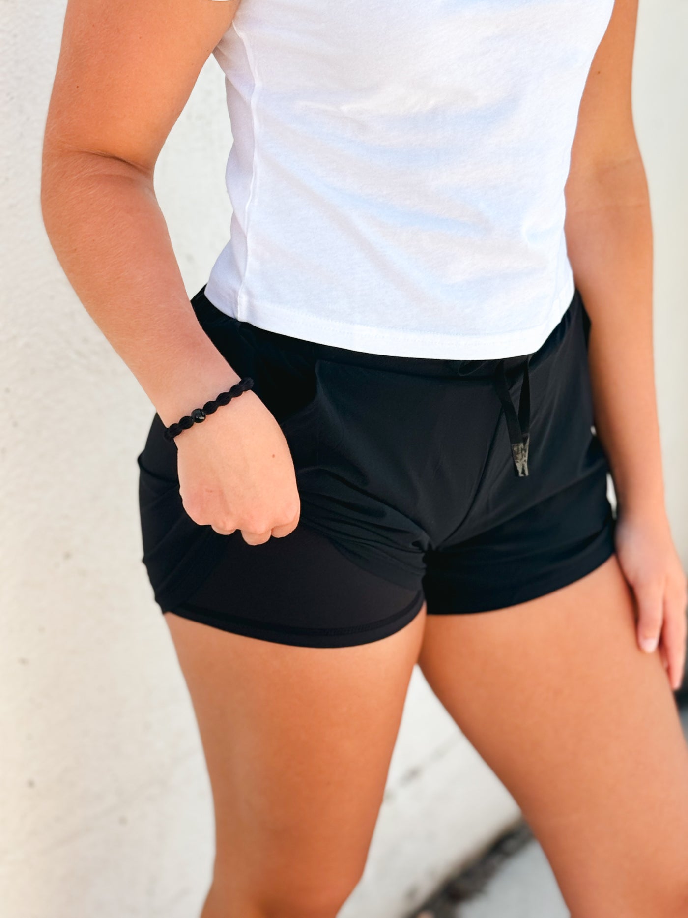 black lined athleisure shorts w/ curved hem